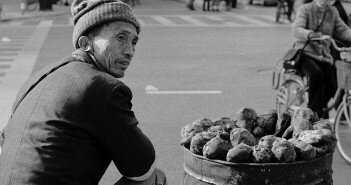 A_man_is_selling_some_sweet_potatoes