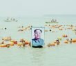 People Crossing the Yellow River with a Photo of Mao Zedong